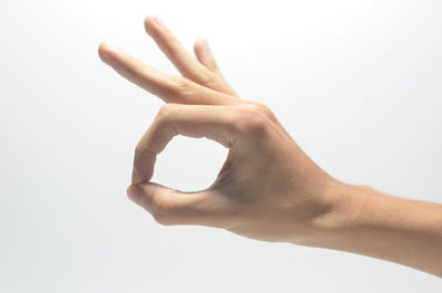 Close-up of human hand against white background