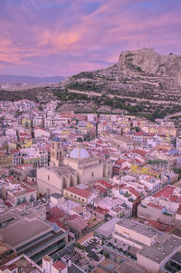 Aerial view of alicante city and santa barbara castle at sunset, spain.