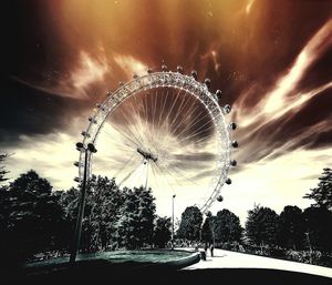 Low angle view of ferris wheel against sky