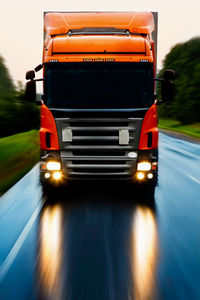 Truck moving on road against sky