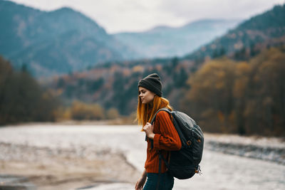 Rear view of young woman standing on land