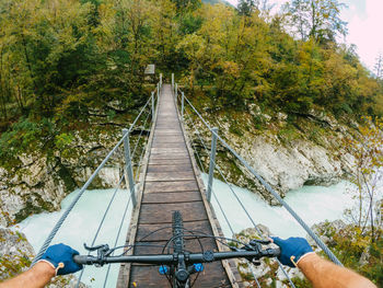 Person riding bicycle on footbridge