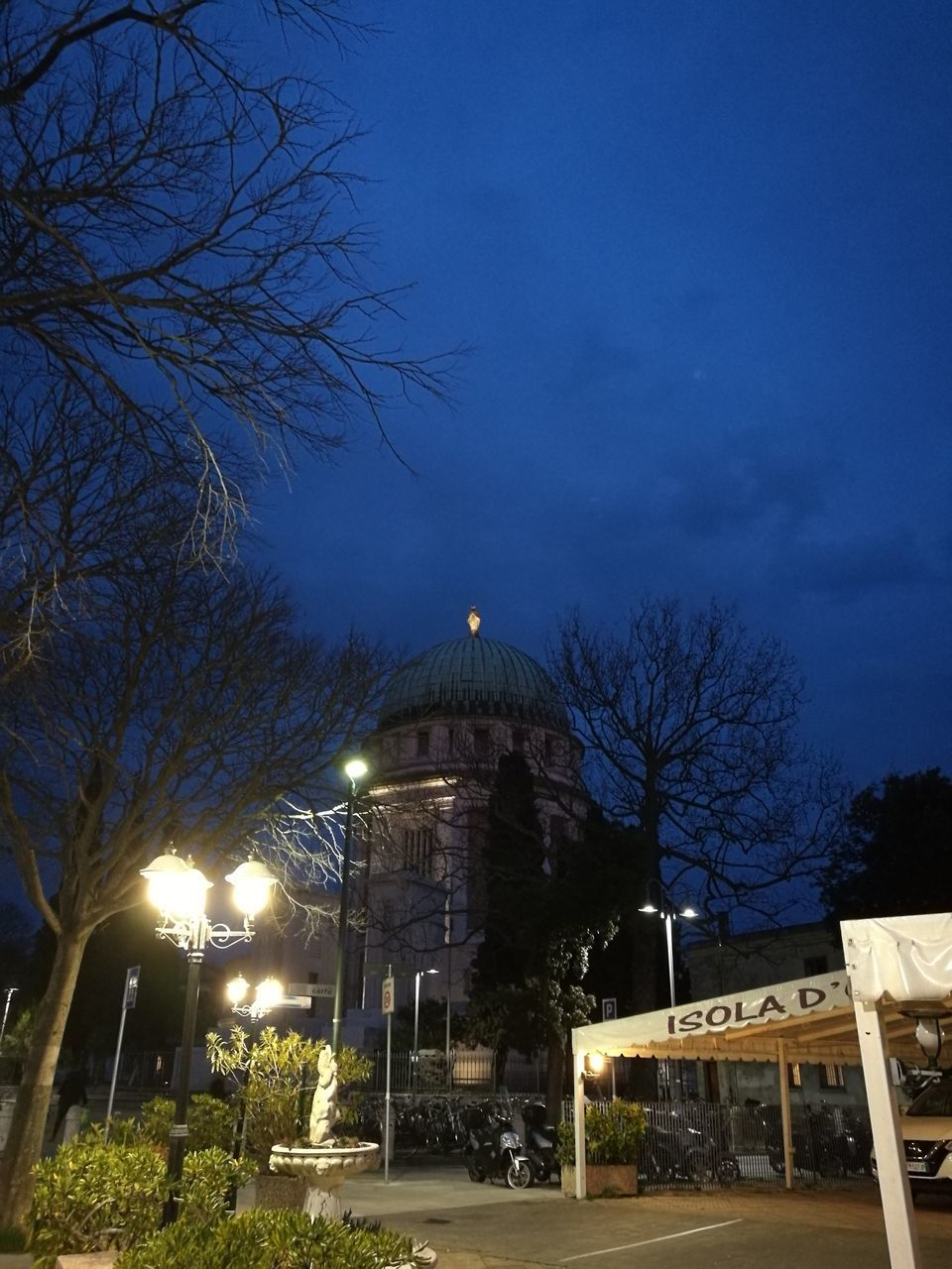 ILLUMINATED STREET AND BUILDINGS AGAINST SKY AT NIGHT