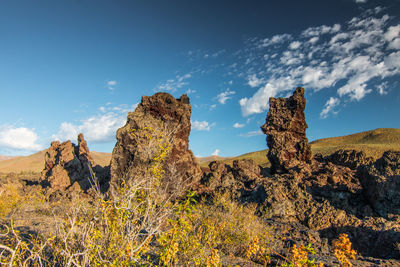 Rock formations on landscape against sky