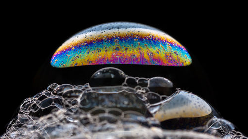 Close-up of bubbles over black background