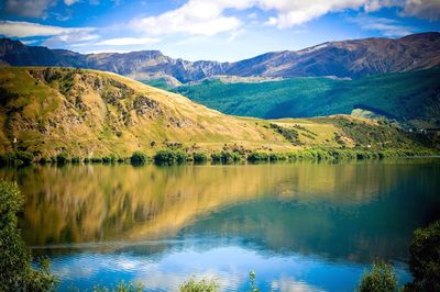 Scenic view of lake with mountains in background