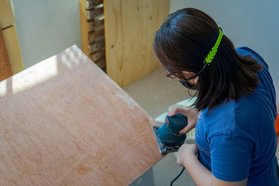 Woman working on wood