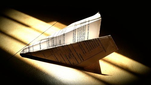 Close-up of paper airplane on floor