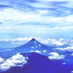 Scenic view of mountains against cloudy sky