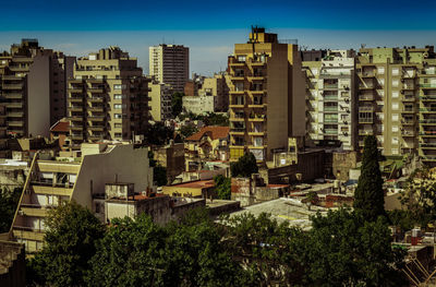 Buildings in city against clear sky