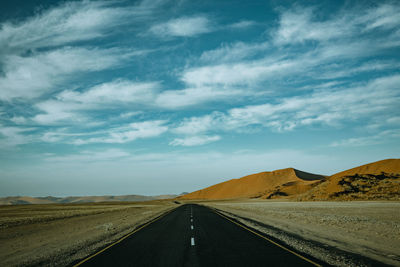 Empty road along countryside landscape