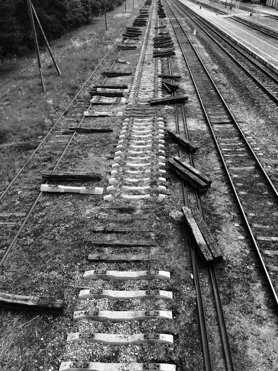 HIGH ANGLE VIEW OF OLD RAILROAD TRACKS ON FIELD