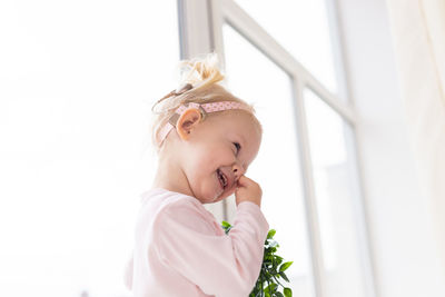 Portrait of cute girl holding bouquet