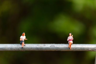 Female figurines on metal