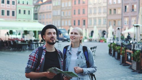 Young couple standing in city