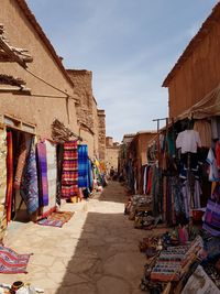 Clothes drying against buildings at market stall