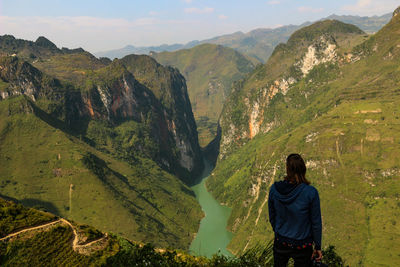 Rear view of man looking at mountains