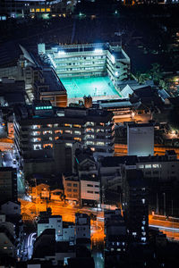 High angle view of illuminated buildings in city at night