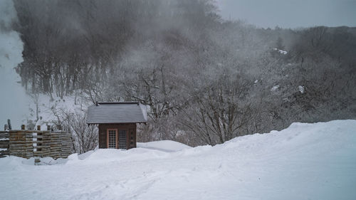 House on snow covered landscape