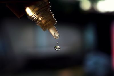 Close-up of drop falling from bottle