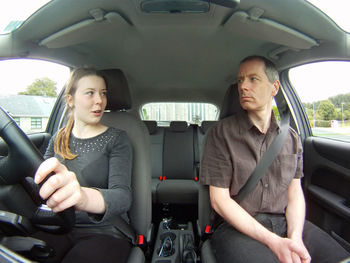 Portrait of a mid adult couple in car