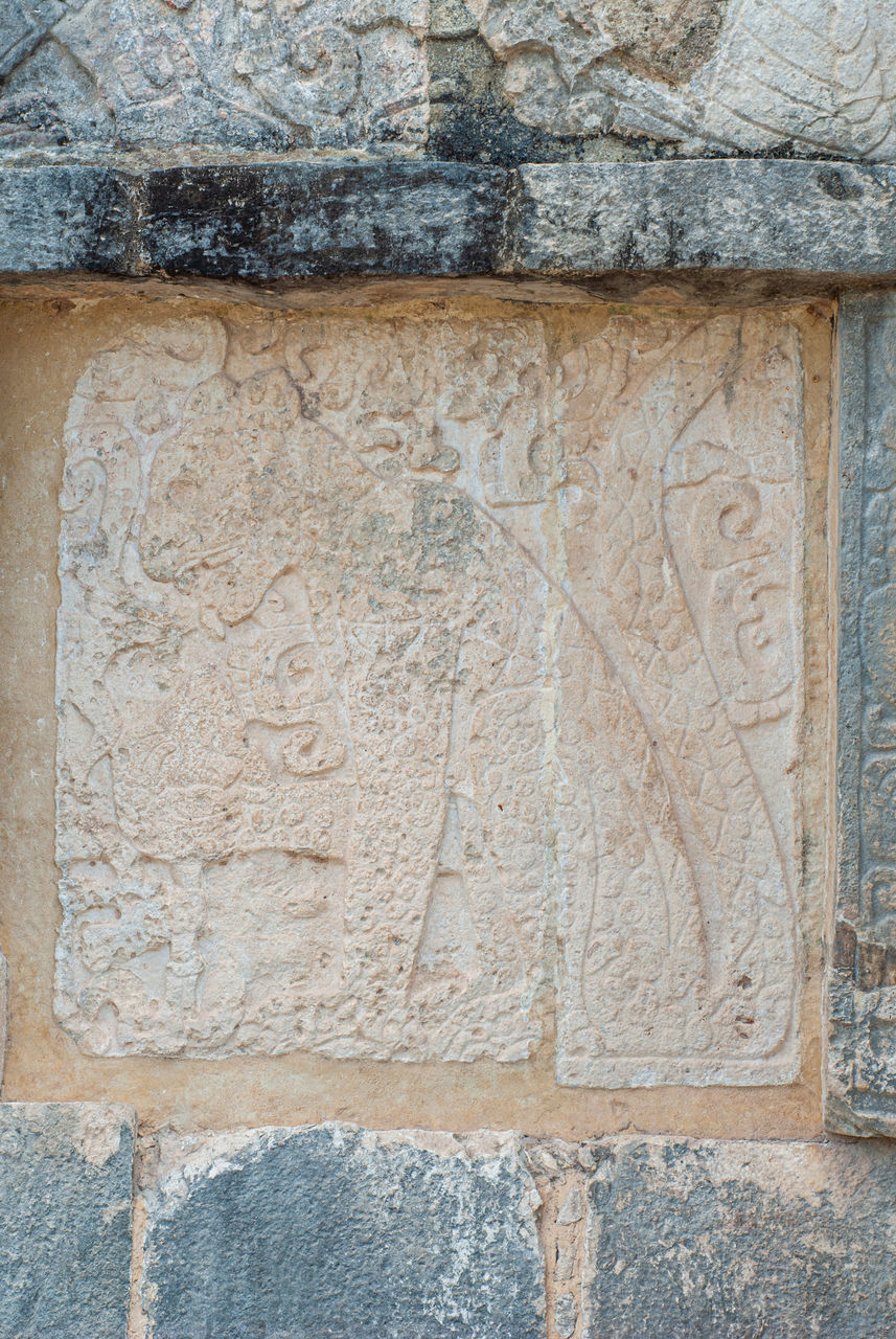 CLOSE-UP OF STONE WALL WITH TEXT