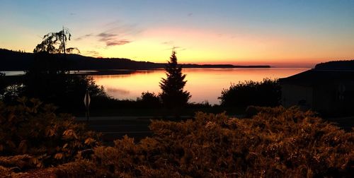 Scenic view of lake against orange sky