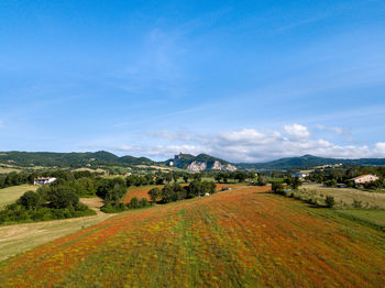 Scenic view of farm against sky