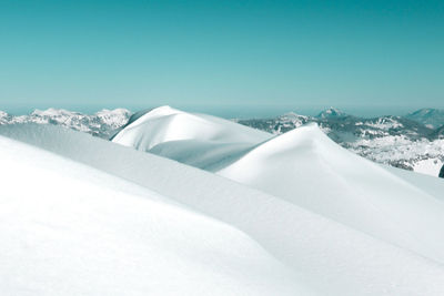 Snow covered landscape against sky