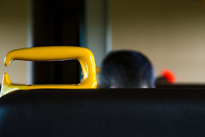 Close-up of handle on seat in train