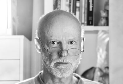 Close-up portrait of man wearing eyeglasses