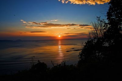 Scenic view of sea against romantic sky at sunset