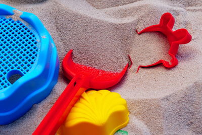 High angle view of multi colored toy on sand