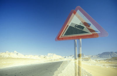 Scenic view of desert against clear blue sky