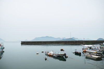 Boat in calm water against clear sky