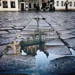 Reflection of buildings in puddle