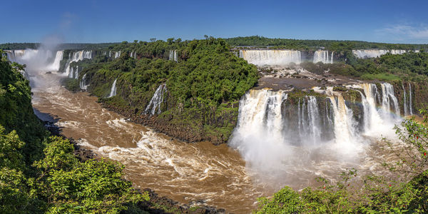 Scenic view of waterfall against sky