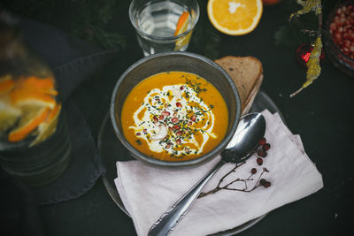 High angle view of sweet potato soup and bread on table