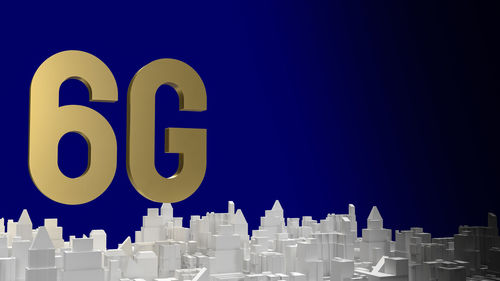 Close-up of text on building against blue sky