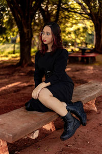 Teenager sitting on bench at park