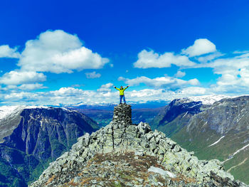 Scenic view of man on topp of rocky mountains against sky