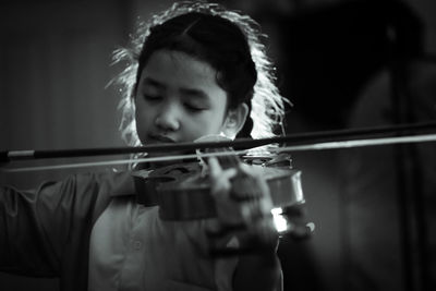 Portrait of boy playing in music concert