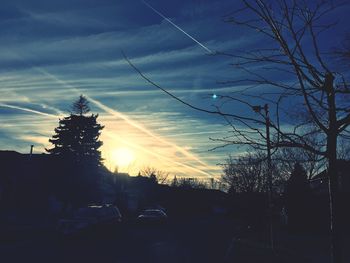 Cars on road against sky during sunset