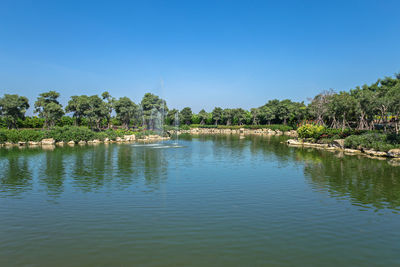 Scenic view of lake against clear blue sky