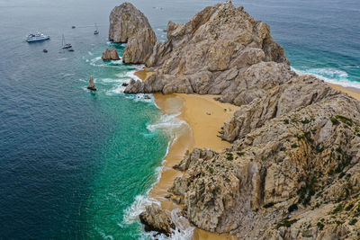 High angle view of rocks on sea shore