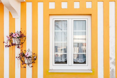 Detail of a typical facade of aveiro, yellow stripped wall.costa nova, aveiro, portugal