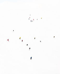 High angle view of people skiing on snow covered land