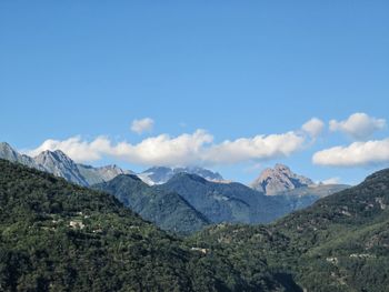 Scenic view of mountains against blue sky