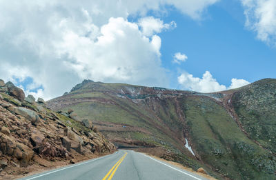 Road amidst mountains against sky