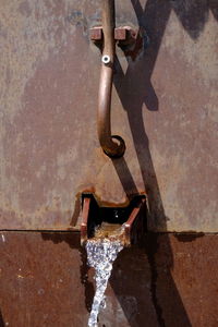 High angle view of rusty metal against wall